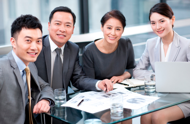 business people at a glass table