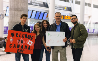 photo of family welcoming others at airport